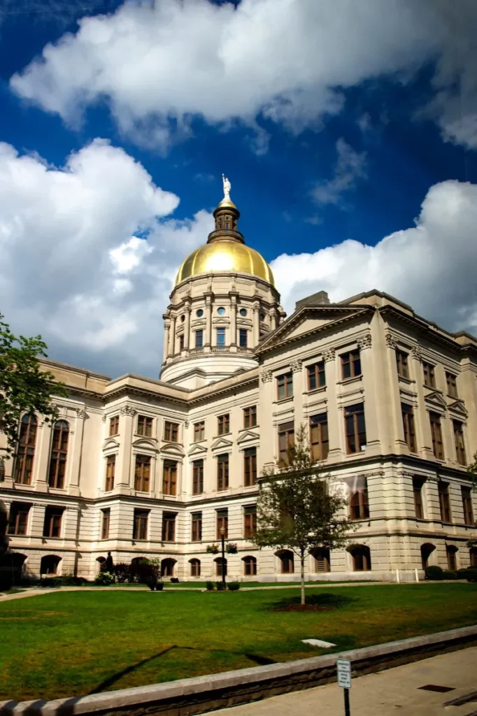 Georgia State Capitol building with its gold dome against a blue cloudy sky