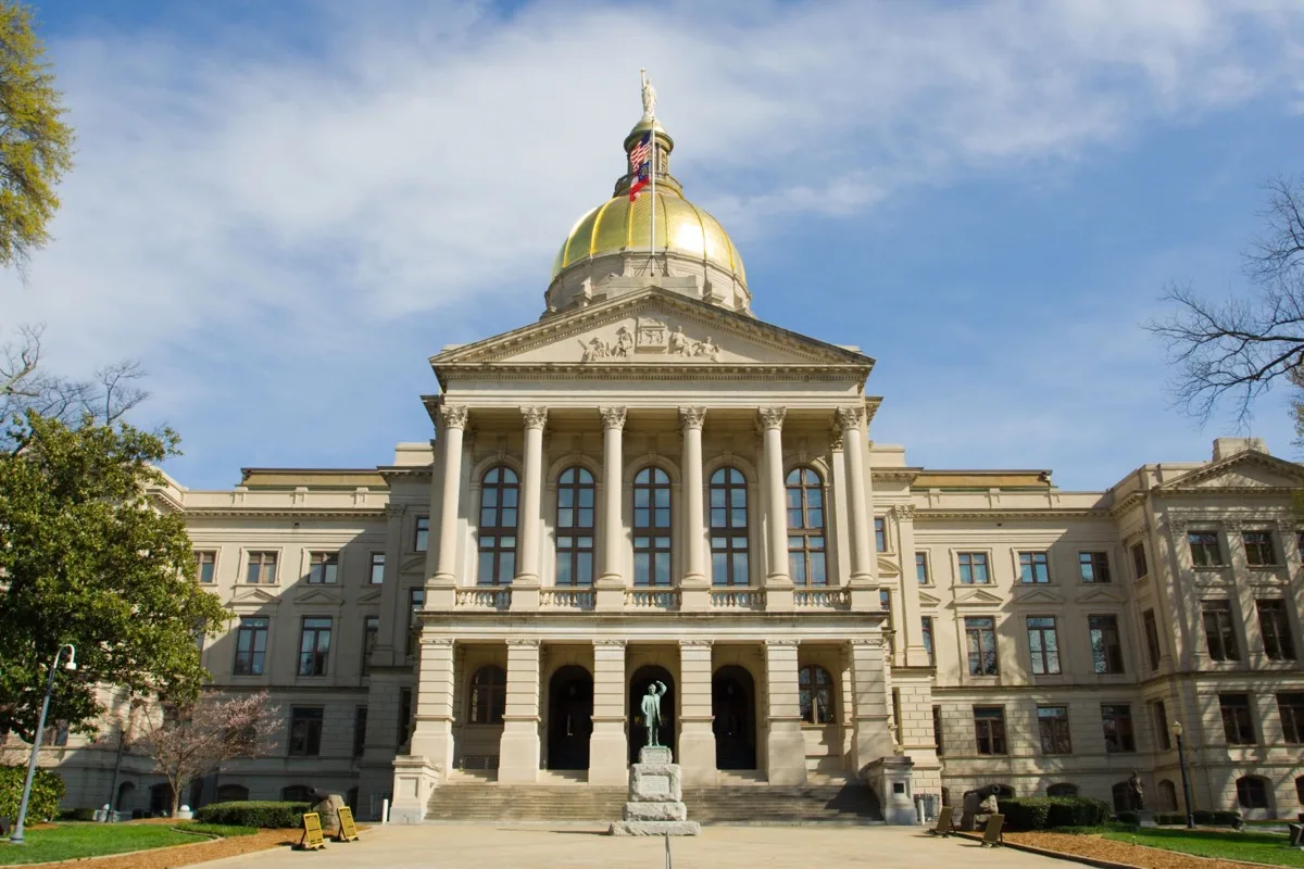 Georgia State Capitol building with gold dome under a blue sky