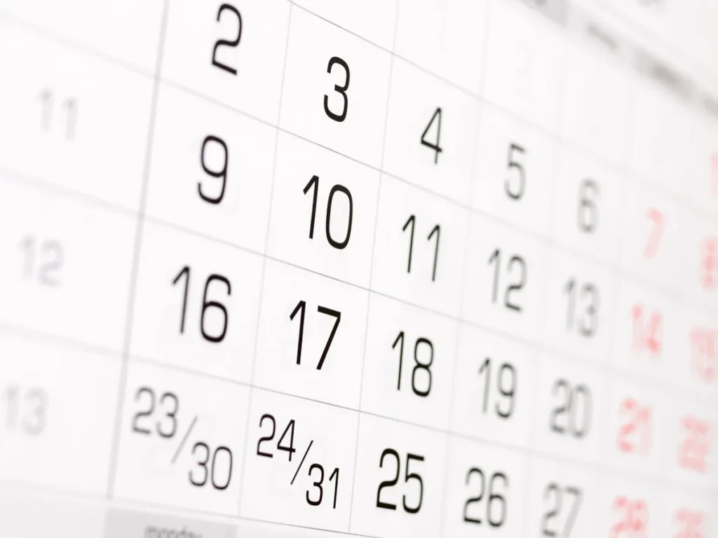 Close-up of a wall calendar showing a month of numbered dates