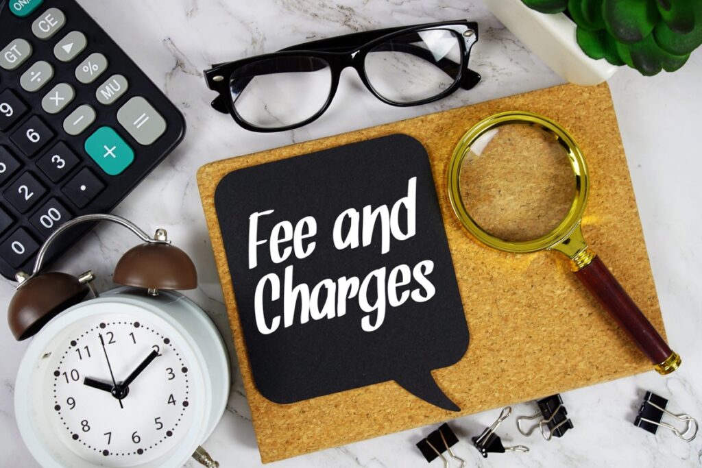 Fee and charges text on a speech bubble with alarm clock, calculator, and magnifying glass