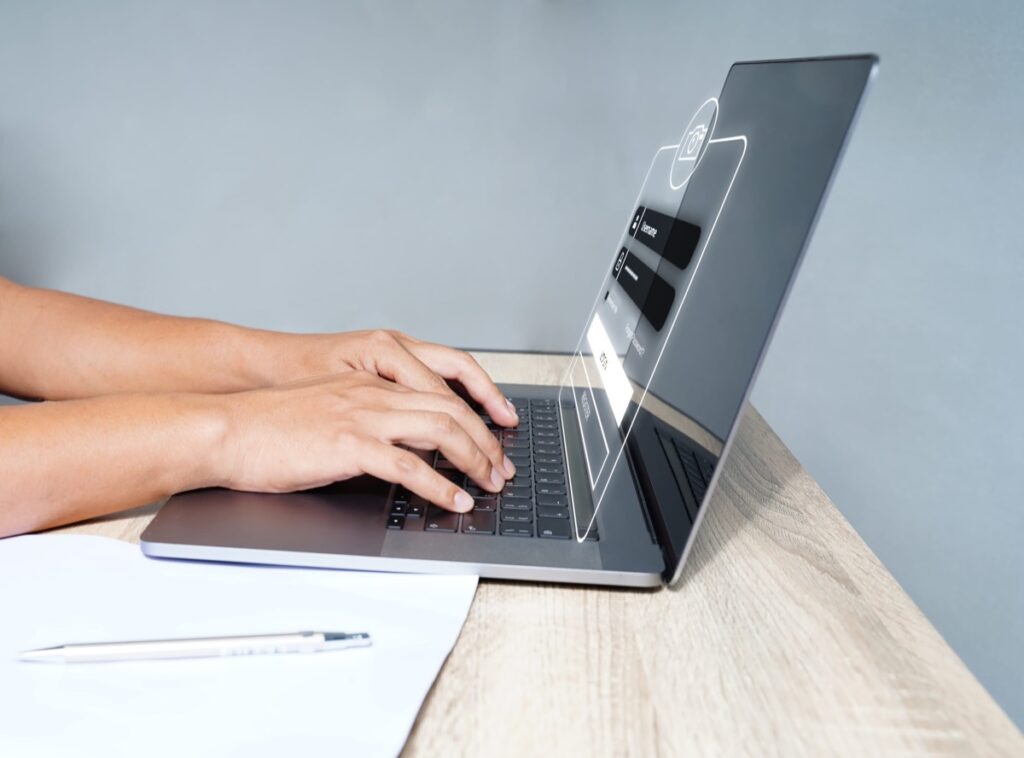 Person logging in securely on a laptop keyboard